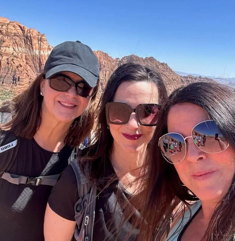 Dr. Julianne Holt-Lunstad (middle) with her sisters Rebekah (left) and Katherine during a hike in southern Utah as part of their annual family trip with all her siblings, nieces and nephews. (Photo courtesy of Dr. Julianne Holt-Lunstad)